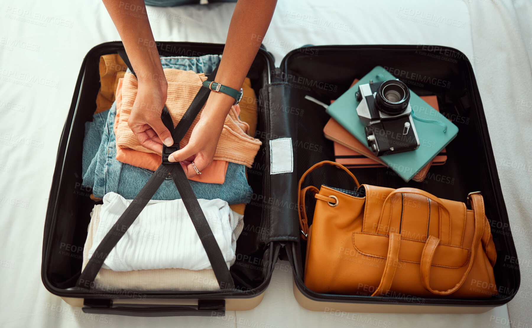 Buy stock photo Travel suitcase, bedroom and hands of woman packing for Europe holiday, vacation or adventure tourist journey. Hospitality, hotel bed and photographer with luggage bag, clothes and camera in Madrid