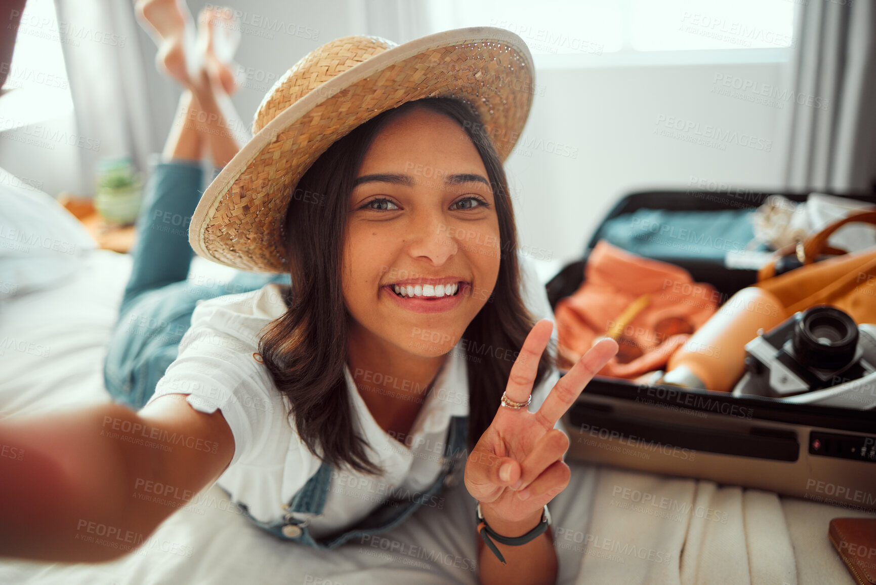 Buy stock photo Portrait, travel and selfie by woman on bed with luggage, smile and happy before leaving for vacation. Face, girl and peaceful hand sign by travelling influencer pose for blog, photo and social media