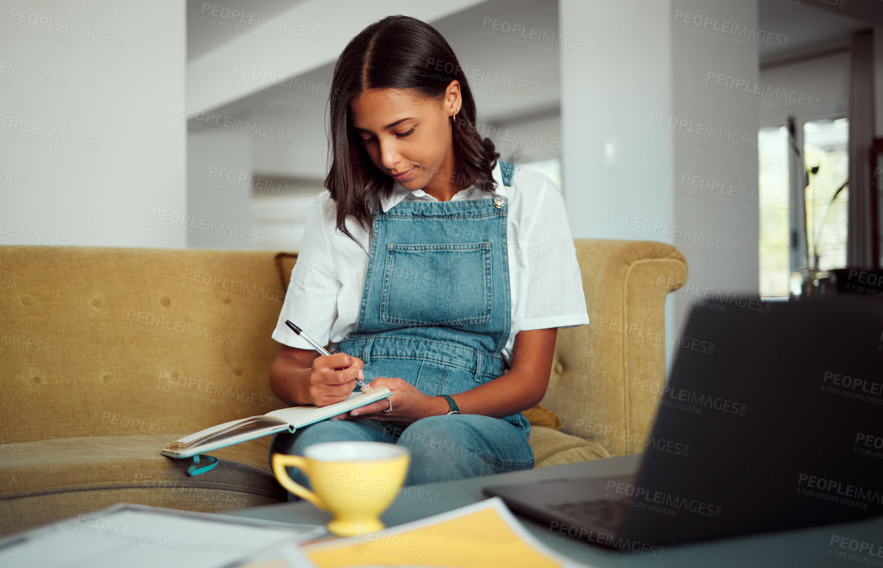 Buy stock photo Girl, student and writing in notebook on sofa for college exam preparation in home lounge. Education, knowledge and notes of university learner studying with focus and concentration in house