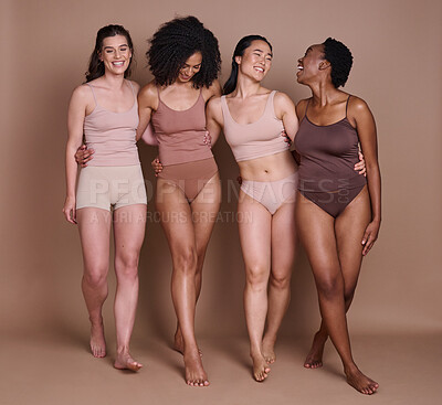Buy stock photo Beauty, skincare and diversity of women with hug and smile for health, wellness and confidence. Body care, natural and cosmetic model group in underwear for inclusive campaign at brown studio.


