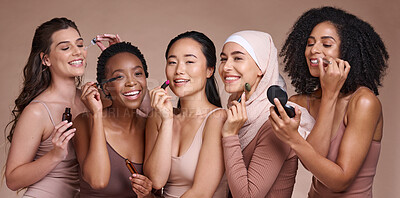 Buy stock photo Face, skincare makeup and group of women in studio on a brown background. Beauty portrait, diversity and female models with cosmetics, products or lipstick, jade roller or serum, lip gloss or mascara