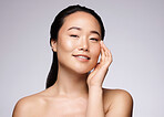 Portrait, Asian woman and cosmetics for skincare, face detox and organic facial on grey studio background. Female, girl and makeup for natural beauty, body care or wellness for health and smooth skin