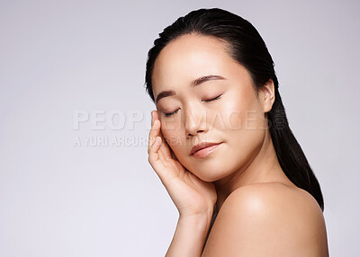 Buy stock photo Wellness, relax and skincare of asian model feeling smooth texture for facial cosmetic marketing. Dermatology glow and healthy skin touch of woman in gray studio with advertising mockup.