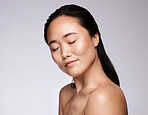 Face, beauty skincare and Asian woman with eyes closed in studio on a mock up background. Relax, natural cosmetics and female model in makeup with glowing and healthy skin after facial treatment.