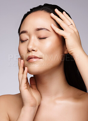 Buy stock photo Asian, health and skincare face of model for natural facial and body care glow cosmetics campaign. Aesthetic, wellness and beauty of woman touching healthy, clean and hydrated skin in gray studio.