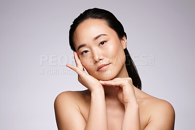 Buy stock photo Skincare, beauty and Asian woman with dermatology glow, luxury cosmetics and body wellness on a grey studio background. Spa, health and face portrait of a model for skin, cosmetology or beauty salon
