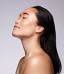 Asian woman, face or skincare glow on studio background in Japanese dermatology, self love or holistic collagen treatment. Natural, makeup cosmetics or relax beauty model with health facial wellness