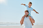 Father, kid and piggy back at beach on vacation, holiday or summer trip. Family love, care and portrait of man bonding with boy while carrying him on shoulders, having fun and enjoying time together