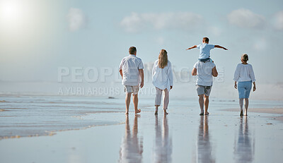 Buy stock photo Family, beach and men with women and child from back with blue sky on outdoor summer vacation. Happy family mother, father and kid with piggy back fun walking in sun and quality time together at sea.