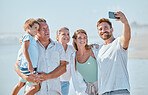 Selfie, family and beach with children, parents and grandparents posing for a photograph by the sea or ocean. Love, kids and holiday with a man, woman and son taking a picture during summer vacation