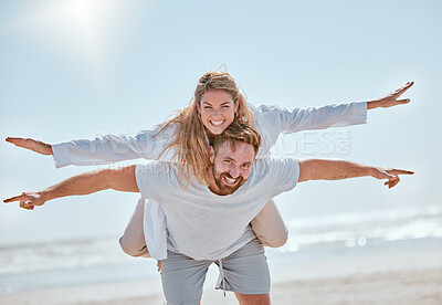 Buy stock photo Playful, travel and couple with freedom at the beach for summer love, quality time and holiday in Costa Rica. Nature, flying piggyback and portrait of man and woman at the ocean for marriage vacation