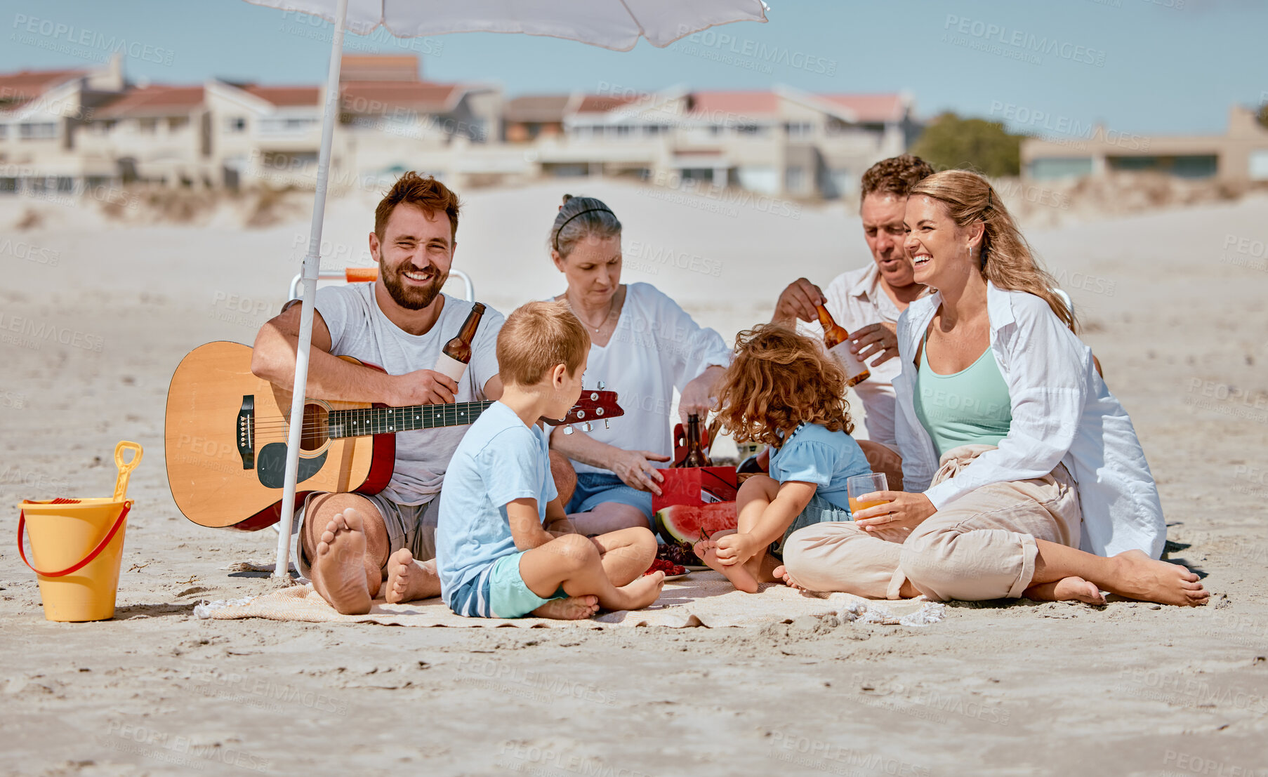 Buy stock photo Summer, picnic and family with guitar at beach enjoying holiday, weekend and vacation on Miami beach. Love, bonding and children with grandparents, mom and dad with musical entertainment outdoors