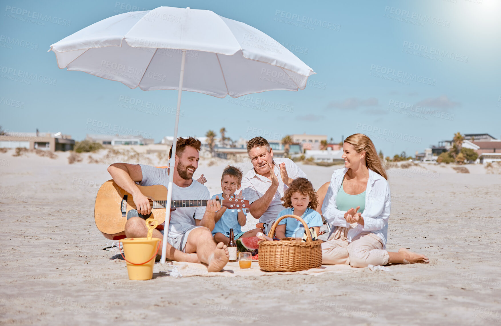 Buy stock photo Beach, picnic or happy family love guitar music while bonding or relaxing on summer holiday vacation. Grandfather, dad and mother enjoying quality time with children siblings eating watermelon fruit