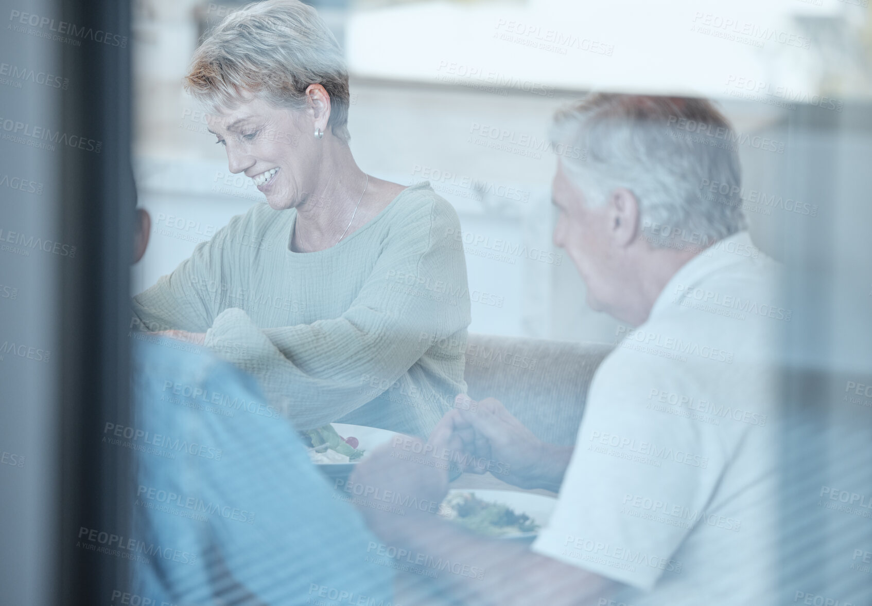 Buy stock photo Love, celebration and family with dinner through window enjoy festive meal, lunch and eating food together. Christmas, thanksgiving and grandparents bonding, happy and laugh at dinner party at home