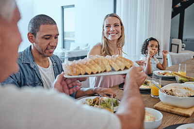 Buy stock photo Interracial family dinner, food and happiness with bonding, bread and celebration for thanksgiving. Happy family, lunch or brunch in family home for christmas, party or giving for love in Los Angeles