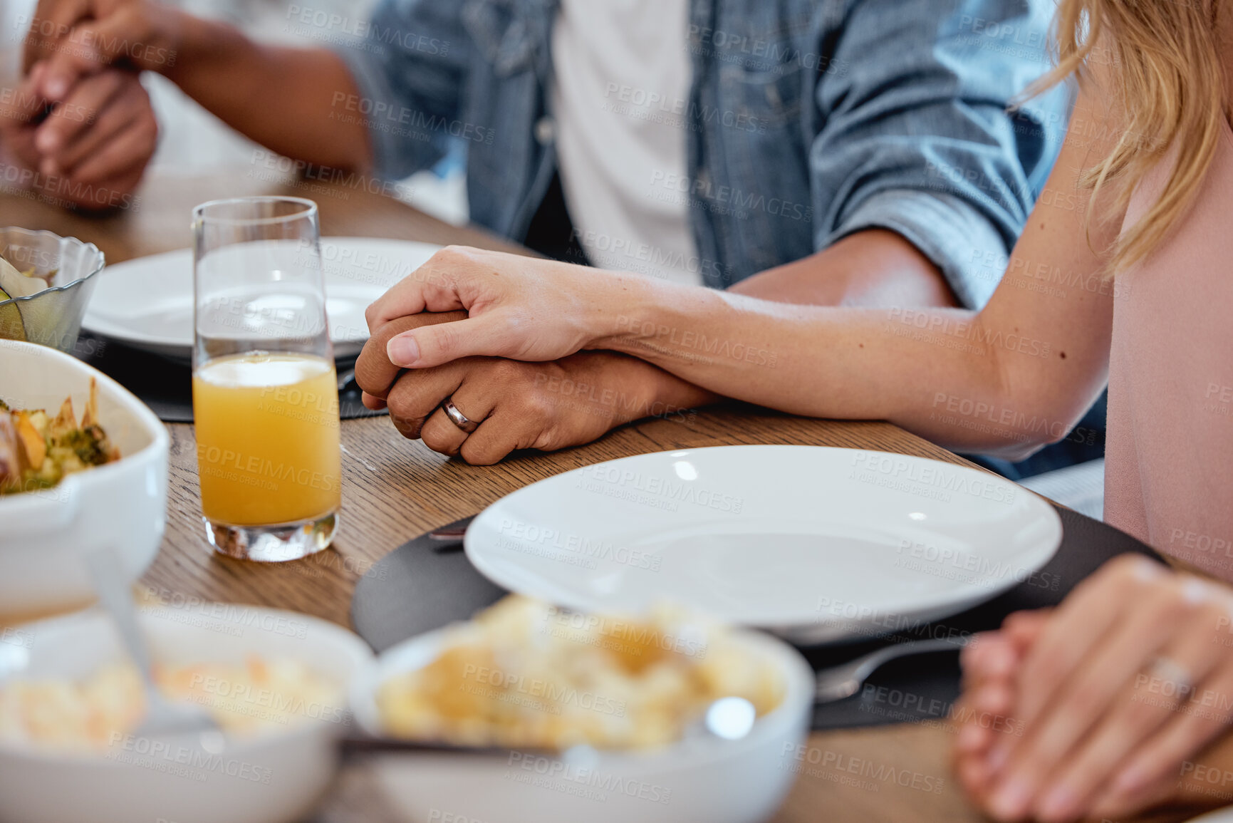 Buy stock photo Holding hands, praying and food with a family grace around the dinner table during a thanksgiving celebration. Prayer, trust and love with a group of people enjoying lunch during a social gathering