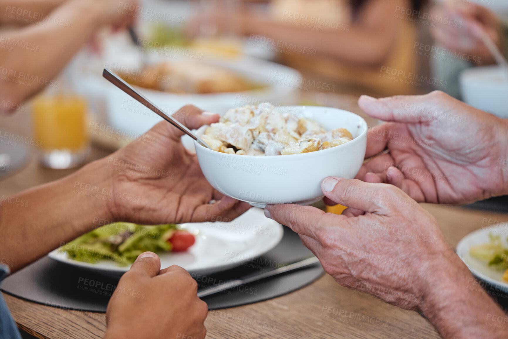 Buy stock photo Lunch, family celebration and hands with potato salad, party food and group eating at the dining room table. Nutrition, healthy food and friends hosting a home dinner with a salad for health