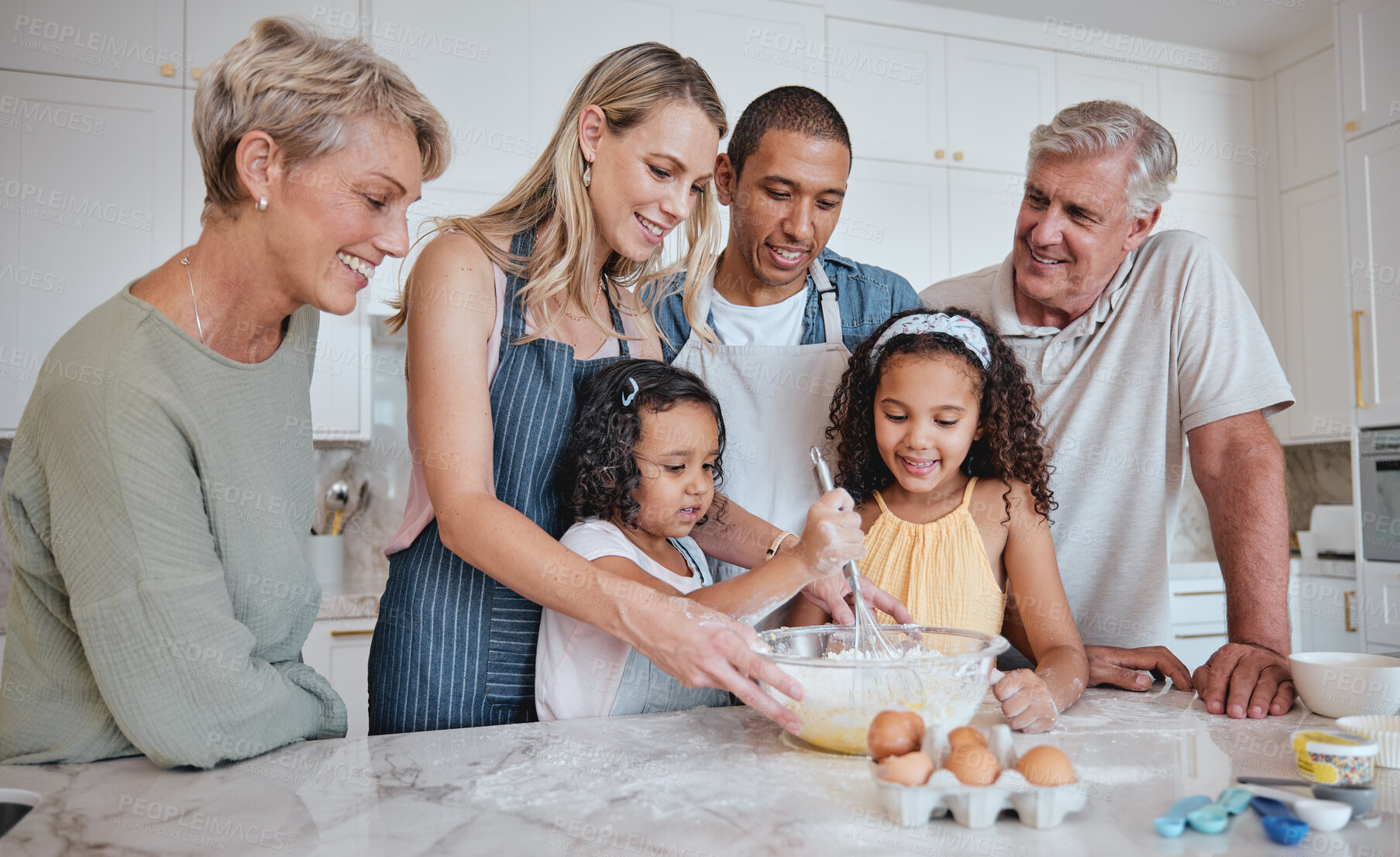 Buy stock photo Family in kitchen, baking and grandparents with kids, parents and bonding for quality time, love and smile together. Mother, father and daughters with grandmother, grandfather and cooking on weekend.