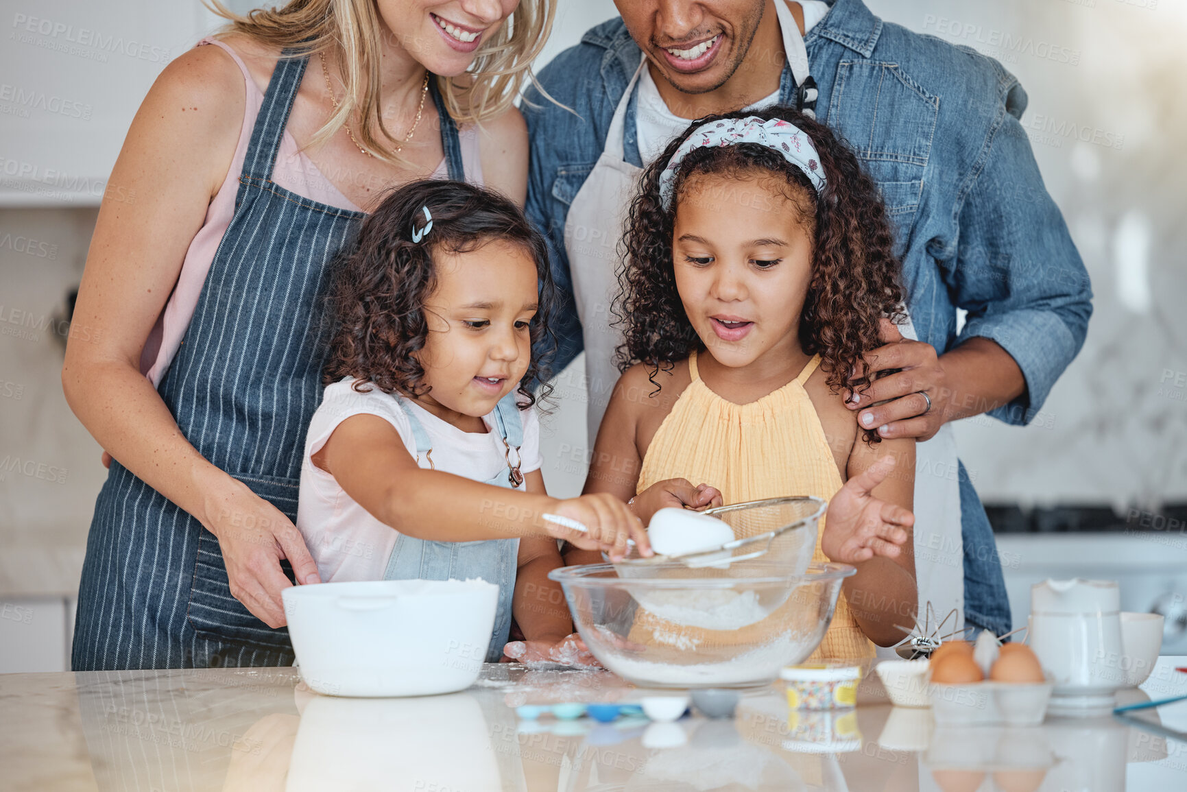 Buy stock photo Love, parents and girls in kitchen, baking and happiness for weekend break, child development and relax. Mother, father and daughters cooking, family bonding and fun with food, ingredients and home.