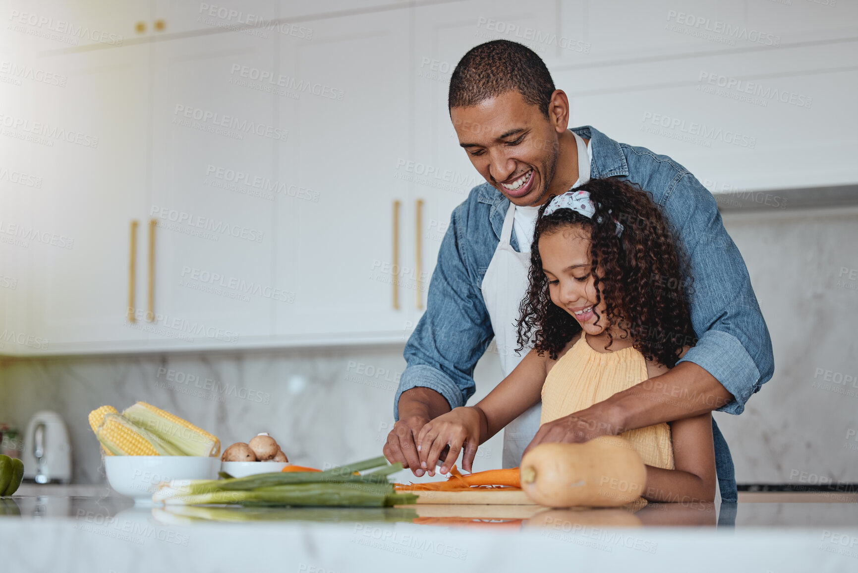 Buy stock photo Love, father and girl cooking food with healthy vegetables for lunch or dinner meal as a happy family at home. Nutrition, smile or dad teaching or helping a young child cut carrots on kitchen counter