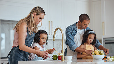 Buy stock photo Family, mother and father with girls in kitchen, rinse vegetables and bonding. Love, mama and dad with daughters, child development and loving to prepare salad together for lunch, veggies and cooking