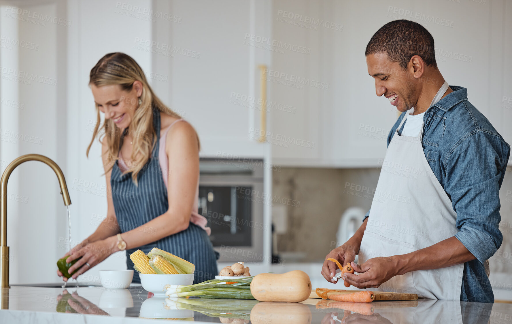 Buy stock photo Cooking, food and love with a couple in the kitchen preparing a meal together for lunch or supper in their home. Health, diet and nutrition with a diversity man and woman bonding while making dinner