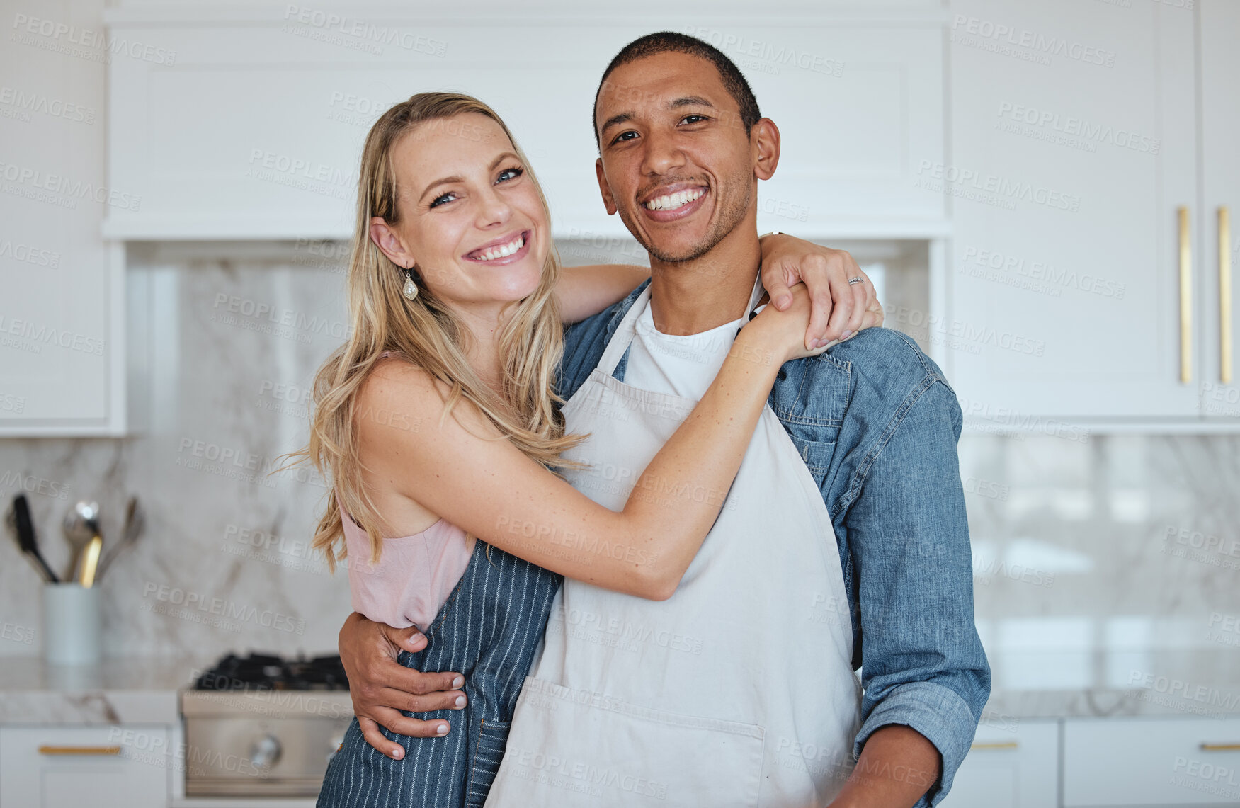 Buy stock photo Kitchen, couple and hug portrait with love, care and smile at home ready for meal cooking. Interracial happy couple loving marriage, diversity and diet nutrition in a house hungry for food together