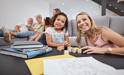 Buy stock photo Happy, living room and mother playing with her child while bonding with the family in modern home. Education, happiness and interracial mom and girl kid learning with wood building blocks in house.