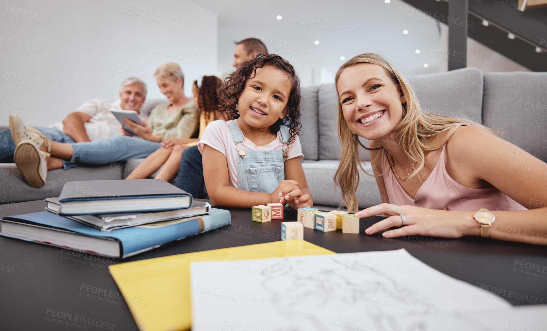 Buy stock photo Happy, living room and mother playing with her child while bonding with the family in modern home. Education, happiness and interracial mom and girl kid learning with wood building blocks in house.