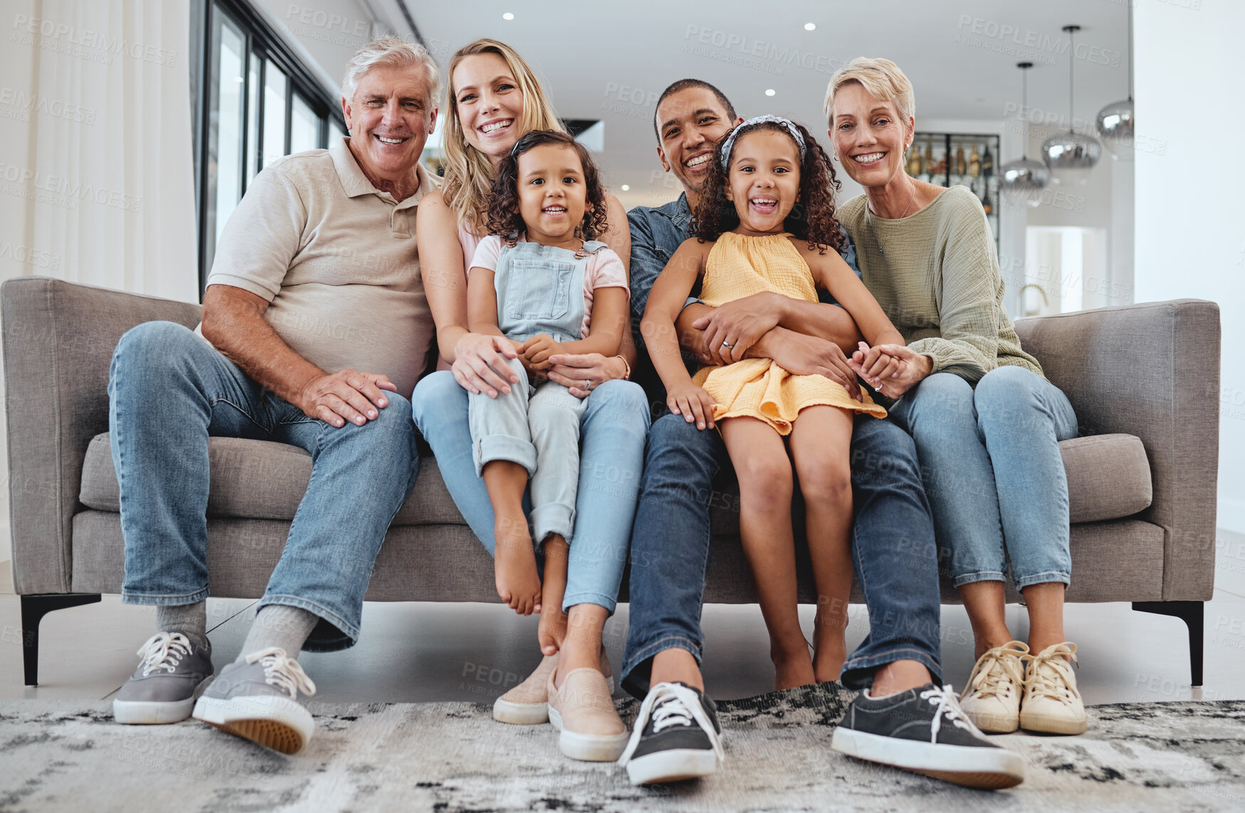 Buy stock photo Love, interracial and family on sofa, grandparents and children relax, portrait and happy together. Grandmother, grandfather and girls with mother, father and bonding in living room, smile or weekend