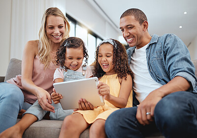 Buy stock photo Love, sofa and family with kids, tablet or social media for streaming, interracial or laugh together. Digital, father or mother with female children, device or watch funny videos and happy parents