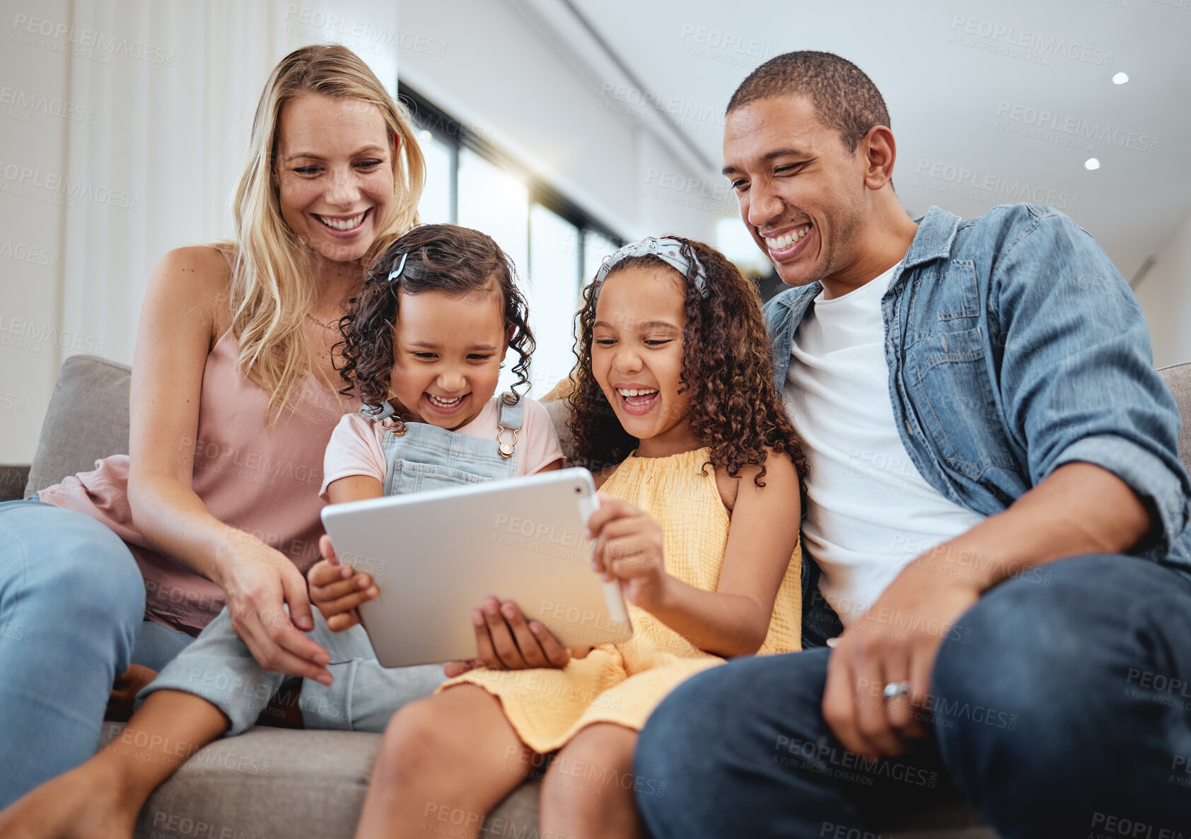 Buy stock photo Love, sofa and family with kids, tablet or social media for streaming, interracial or laugh together. Digital, father or mother with female children, device or watch funny videos and happy parents