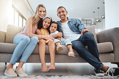 Buy stock photo Interracial, portrait and family on sofa, love and bonding on weekend, break and smile together. Multiracial, man and woman with daughters, kids and in living room for quality time, happy and couch.