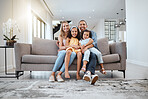 Portrait, love hug and family on sofa in living room, smiling and bonding. Care, support and happy mother, father and girls hugging, embrace or cuddle on couch, having fun and enjoying time together.