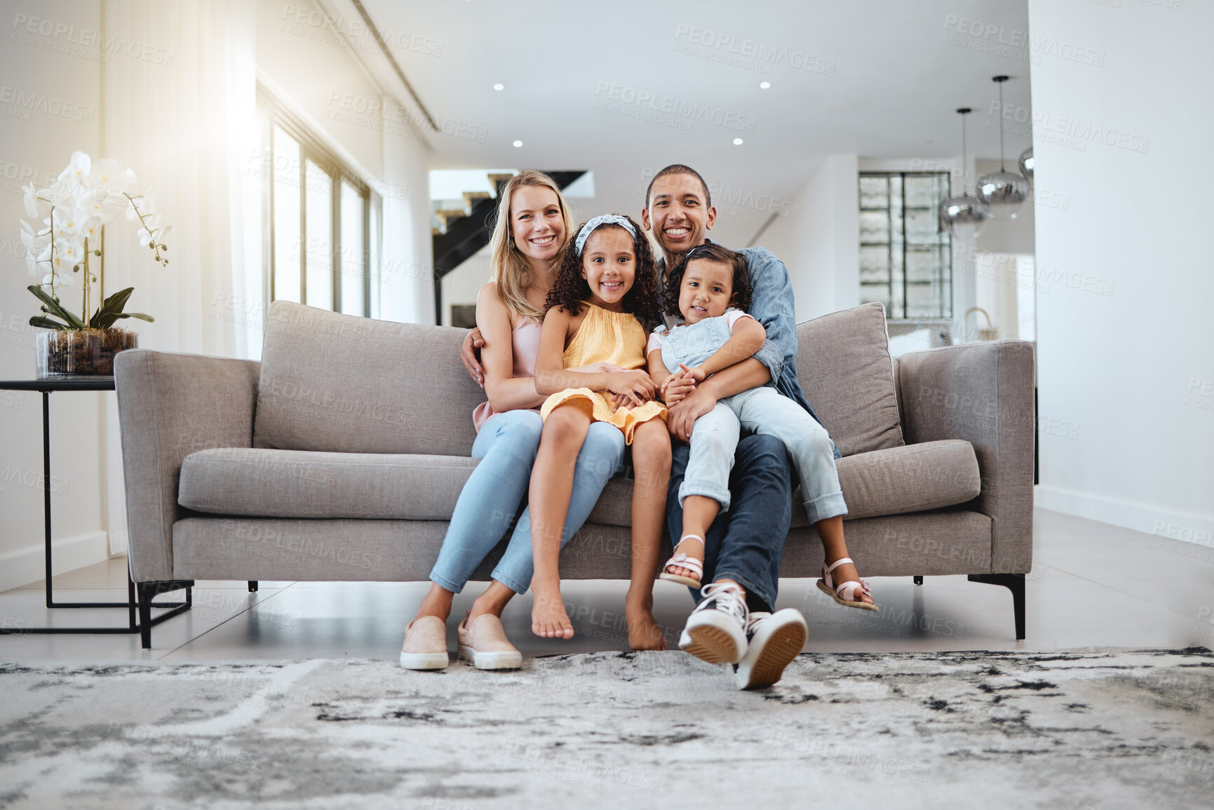 Buy stock photo Portrait, love hug and family on sofa in living room, smiling and bonding. Care, support and happy mother, father and girls hugging, embrace or cuddle on couch, having fun and enjoying time together.