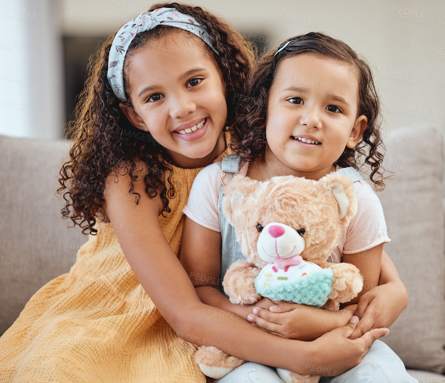 Buy stock photo Family, children hug and portrait of girls on sofa in living room while holding teddy bear. Love, care and happy kids, sisters and siblings bonding, embrace and hugging on couch in lounge of house.