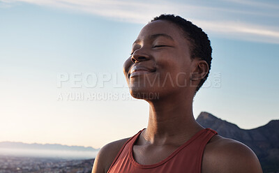 Buy stock photo Fitness, calm and breathing of black woman outdoor in nature, mountains and blue sky background for yoga wellness, meditation and zen energy. Face of girl breathing for peace, freedom and mindfulness