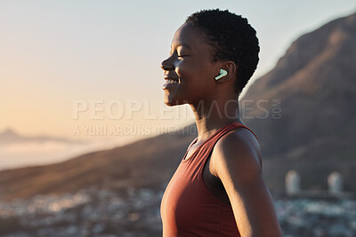 Buy stock photo Headphones, fitness or zen black woman on a mountain for peaceful, calm and breathing in relaxing fresh air. Breathe, healthy or happy sports athlete with smile streaming radio music, song or podcast