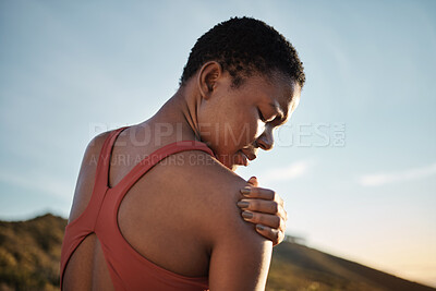 Buy stock photo Shoulder, black woman and exercise injury from outdoor sports training on sky background. Athlete, arm and joint pain, muscle problem and first aid emergency from wound, fitness and workout mistake 