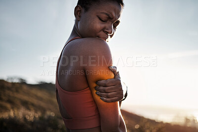 Buy stock photo Black woman, sports fitness and arm pain after exercise accident outdoors. Sunset, health and young female athlete with muscle injury, inflammation or fibromyalgia after intense workout or training