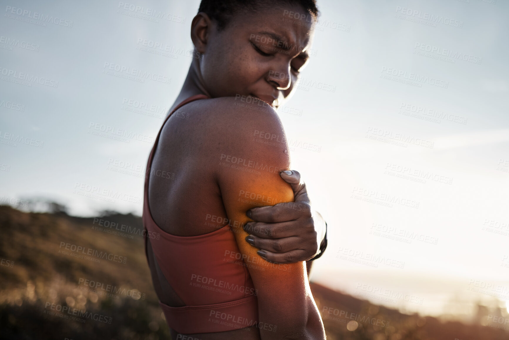 Buy stock photo Black woman, sports fitness and arm pain after exercise accident outdoors. Sunset, health and young female athlete with muscle injury, inflammation or fibromyalgia after intense workout or training