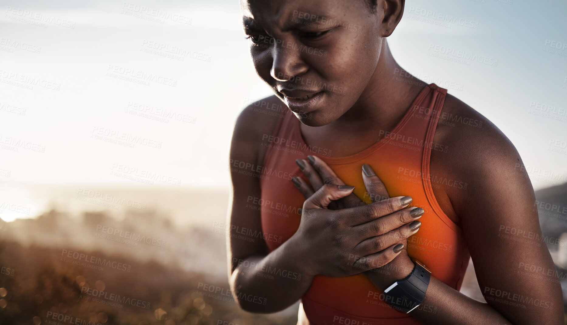 Buy stock photo Heart pain, fitness and black woman with an injury from cardio, running and nature workout in Germany. Asthma, health and African runner with heart attack risk during training on the mountain