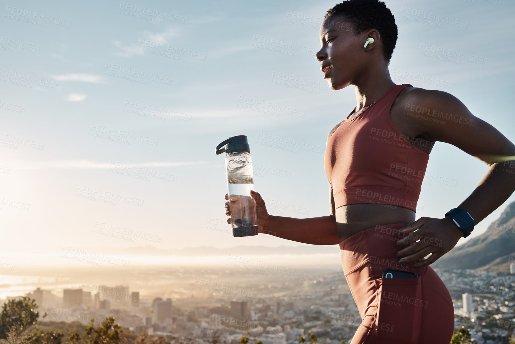Buy stock photo Black woman, water bottle or earphones in running workout goals, healthcare wellness training or sunset city exercise. Fitness drink, sports athlete or runner listening to motivation radio at sunrise