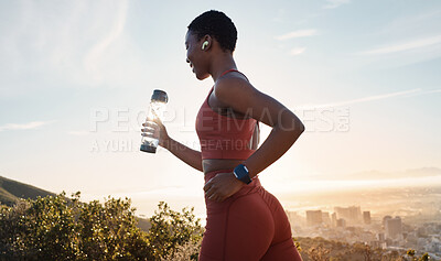 Buy stock photo Workout, black woman or sunset with runner training, exercise for wellness, health or hydration. African American female, lady or athlete with water bottle, practice for marathon or fitness in nature