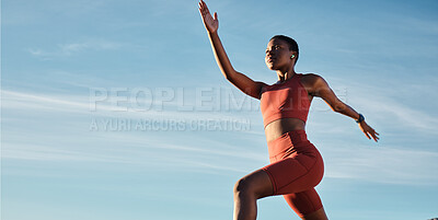 Buy stock photo Black woman, music earphones or running in workout, training or exercise for healthcare, marathon or cardiovascular wellness. Low angle, sports or fitness runner on blue sky background with radio  