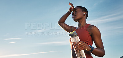 Buy stock photo Water bottle, tired and black woman on break after running, exercise or cardio workout with low angle and mock up. Sports, fitness and sweating female holding liquid for hydration after training.