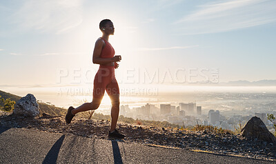 Buy stock photo Black woman, runner and fitness with music on mountain for sports wellness, podcast and cardio training outdoor. African woman, running and exercise workout or streaming radio for freedom in nature