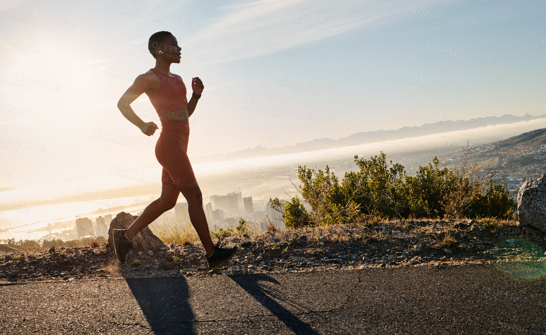 Buy stock photo Running, fitness and black woman with music in the street for training, sports motivation and cardio exercise on mountain in South Africa. Workout, health and African runner with a podcast in nature