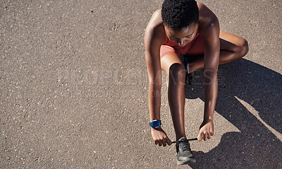 Buy stock photo Black woman, fitness and shoes in preparation for running, exercise or cardio workout on mockup. African American woman runner tying shoe lace getting ready for race, run or sports above on mock up