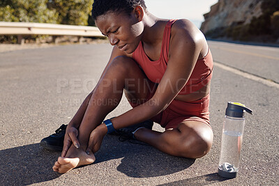 Buy stock photo Black woman, runner and foot injury outdoor, pain and training on road, marathon and water bottle. African American female, girl and athlete with discomfort on heel, suffering and agony for fitness.